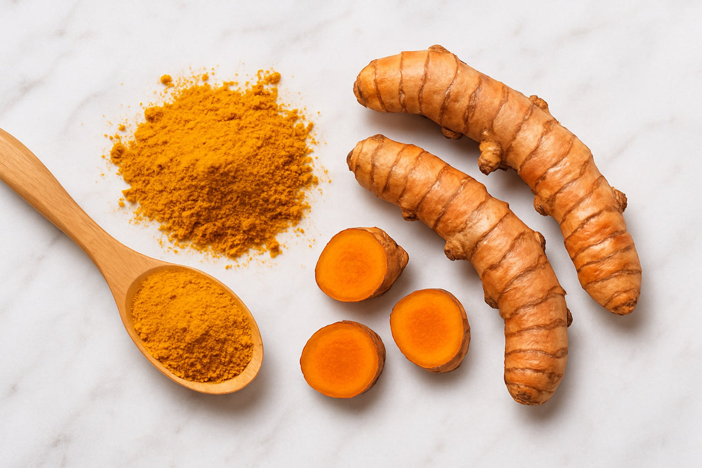 Tumeric root and powder on wooden spoon